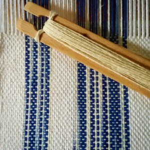 blue and white cotton weaving with shuttle